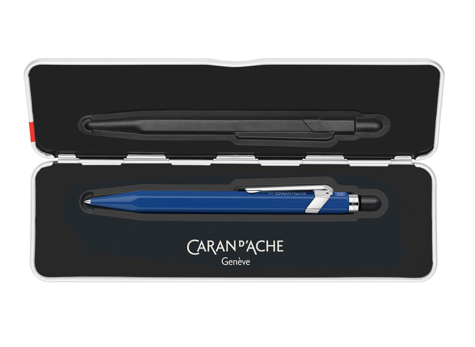 Caran D'Ache Roller Pen 849™ in blue with slim metal barrel and cap, showcasing its sleek design and iconic branding.