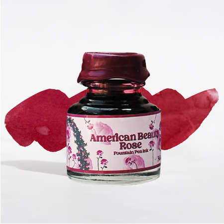 Papier Plume American Beauty Rose fountain pen ink bottle with vibrant pink ink, showcased in a close-up shot.