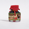 Jar of ink with festive design and red cap on a white background Buche de Noel ink 