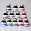 Papier Plume fountain pen ink set of 12 bottles, each 30ml, with colorful ink shades displayed in glass bottles.