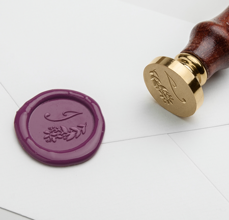 Papier Plume Script Monogram wax seal with elegant monogram design on white background