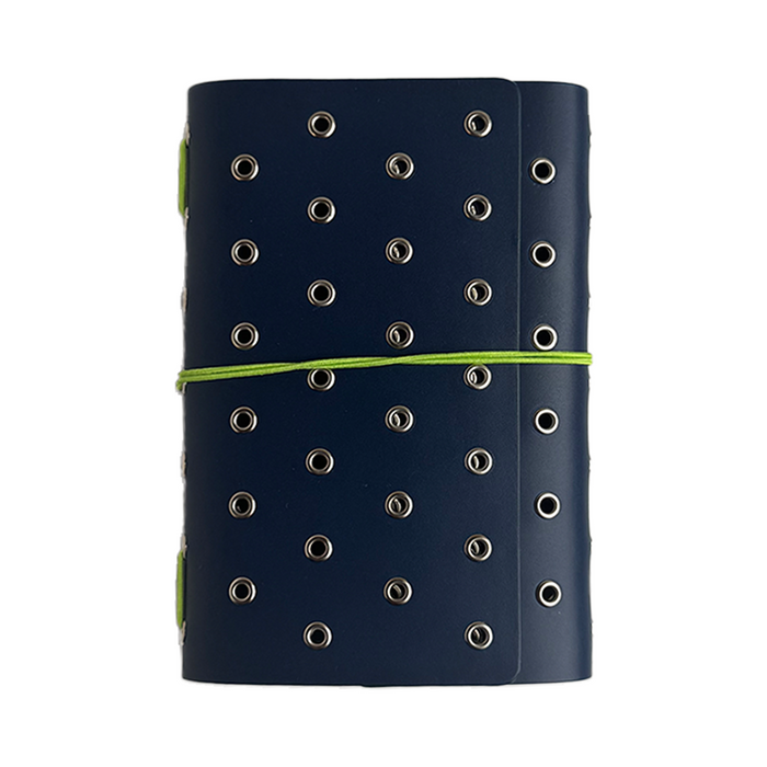 A Juniper-colored A6 journal cover by Imperfect Concepts with deep sea accents and silver grommets, featuring a trifold folio design.