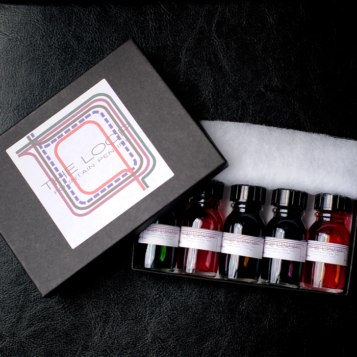 Papier Plume Loop Series fountain pen ink set with multiple ink bottles in various colors, designed for elegant writing.