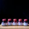 Papier Plume Loop Series fountain pen ink bottle with vibrant ink inside, designed for smooth ink flow and elegant writing.