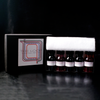 Papier Plume The Loop Series fountain pen ink set with four colorful ink bottles in glass containers.