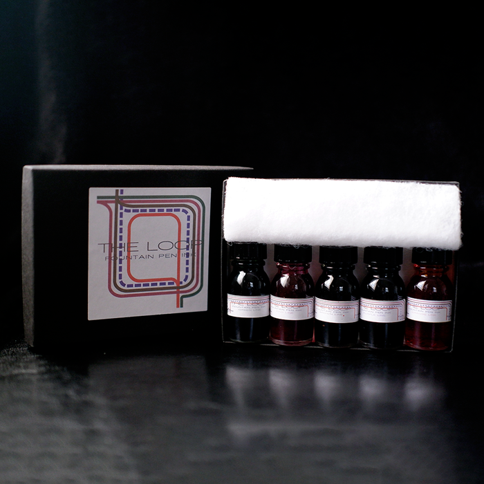 Papier Plume The Loop Series fountain pen ink set with four colorful ink bottles in glass containers.
