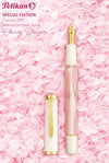 Pelikan M200 Cherry Blossom fountain pen with pink and gold accents, featuring a sleek design and detailed cap.