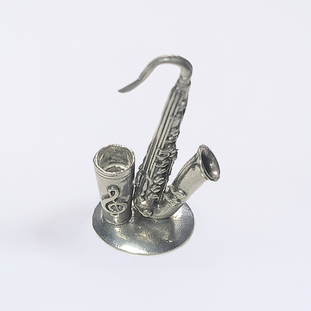 Le Potier D'Étain pewter saxophone-shaped pen rest stand for quill or pens, featuring detailed craftsmanship and a smooth finish.