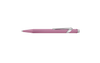 Caran D'Ache Ballpoint Pen 849 with rose-colored barrel and silver accents, close-up showing detailed design and branding.