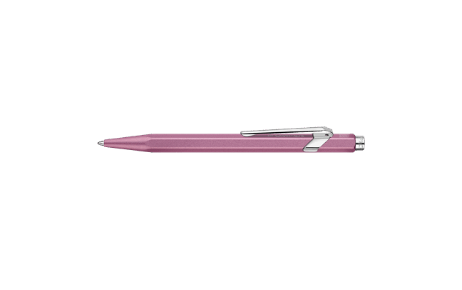 Caran D'Ache Ballpoint Pen 849 with rose-colored barrel and silver accents, close-up showing detailed design and branding.