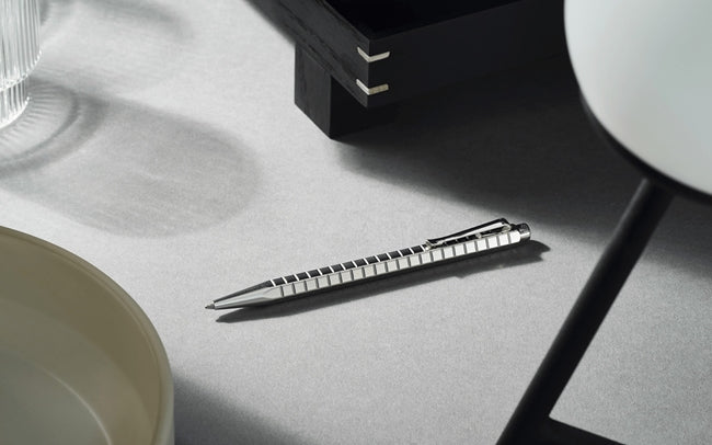 Caran D'Ache Platinum-Coated Ecridor Avenue rollerball pen with detailed close-up of the elegant ballpoint tip and platinum finish.