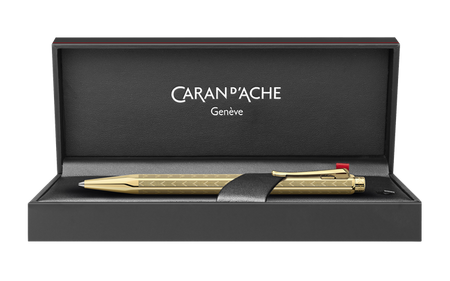 Caran D'Ache Gilded Ecridor Chevron ballpoint pen with gold accents and intricate chevron design, close-up detail image.
