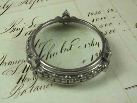 Small pewter magnifying glass on feet with fleur de lys design by Le Potier D'etain, detailed antique-style magnifier.