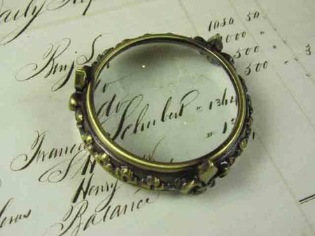 Small pewter magnifying glass on feet with fleur de lys design, by Le Potier D'etain, detailed vintage-style magnifier.