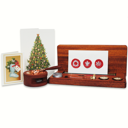 Wooden stamp set with furnace and spoon, wax seals, and a Christmas-themed cards on a white background